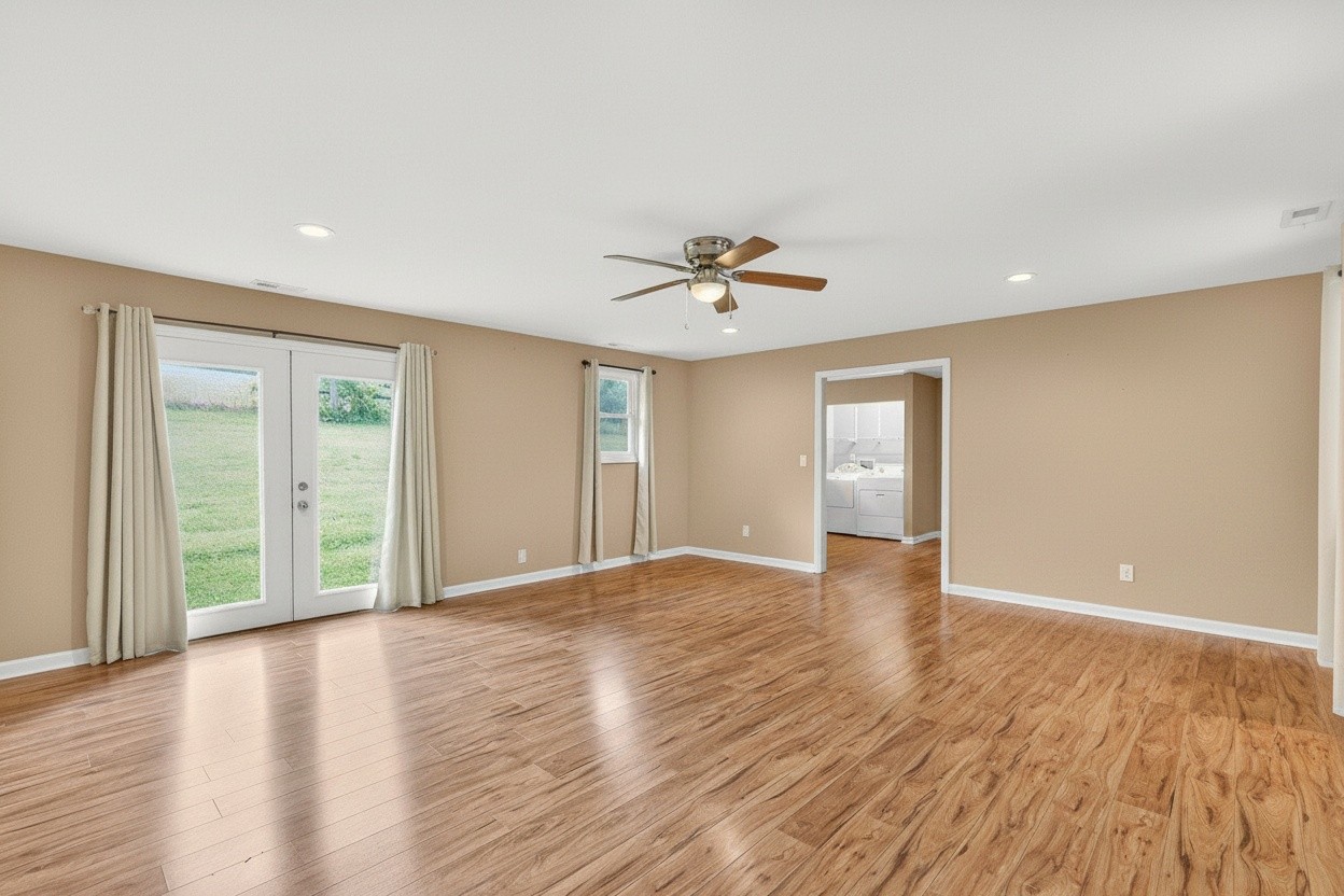 11914 Hogwood Road Milton, TN 37118 - Photo 12 of 44 a view of an empty room with wooden floor and a window