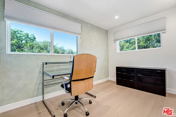 a room with a dresser and a window