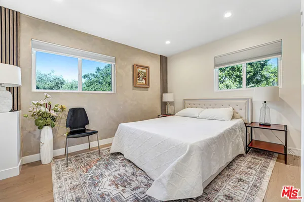 a bedroom with a bed and a chair