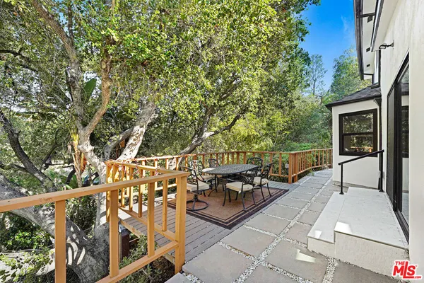 a view of a backyard with wooden fence