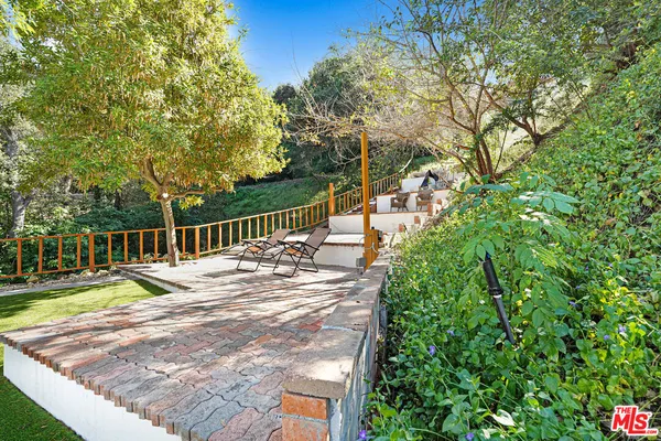 a view of a house with backyard porch and sitting area