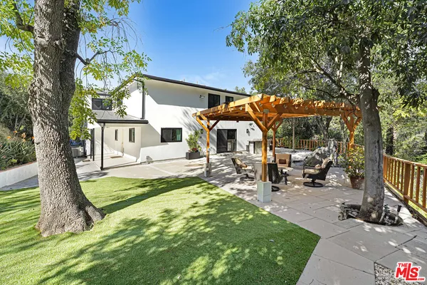 a view of a patio with table and chairs under an umbrella