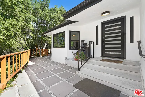 a view of two chairs in the balcony