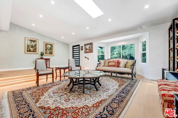 a living room with furniture and a rug