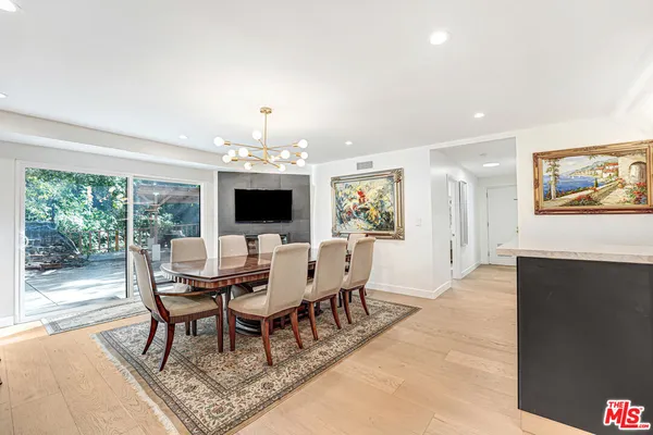 a dining room with furniture a rug and a chandelier