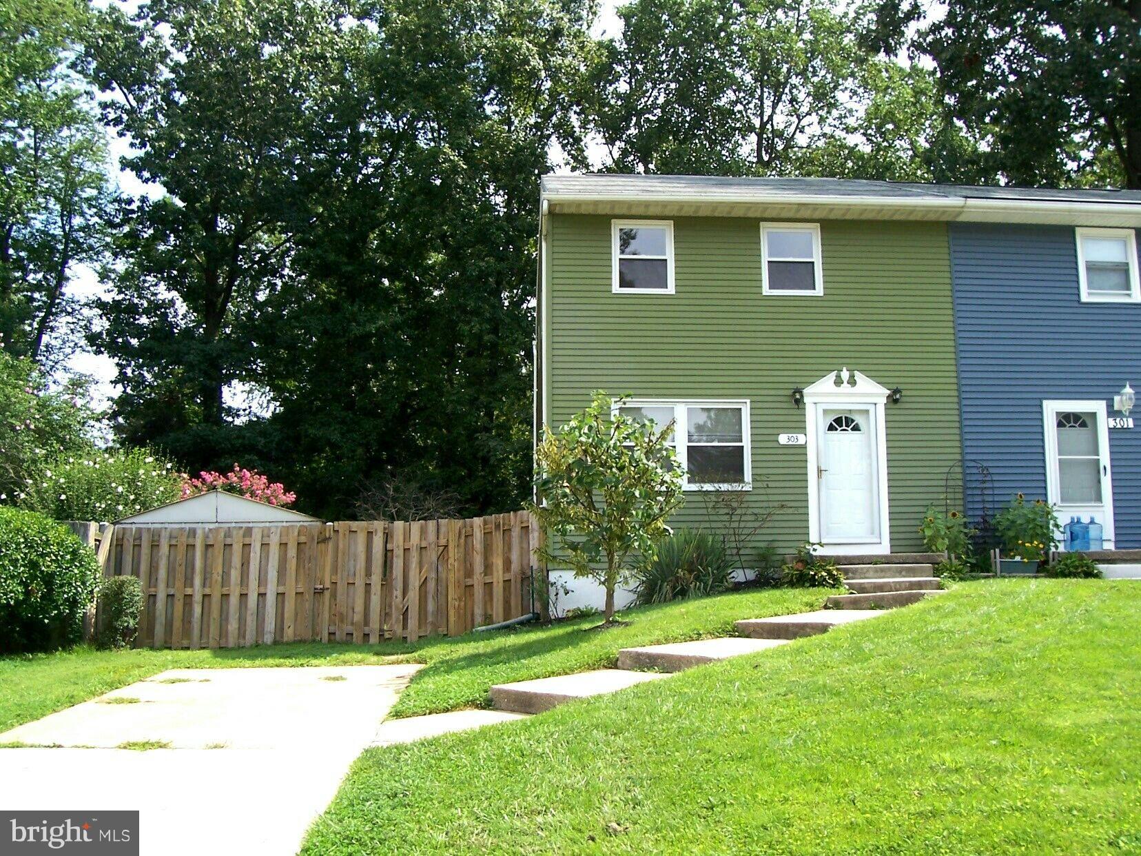 303 Redbud Road Edgewood, MD 21040 - Photo 1 of 16 a front view of a house with a yard garage and fence