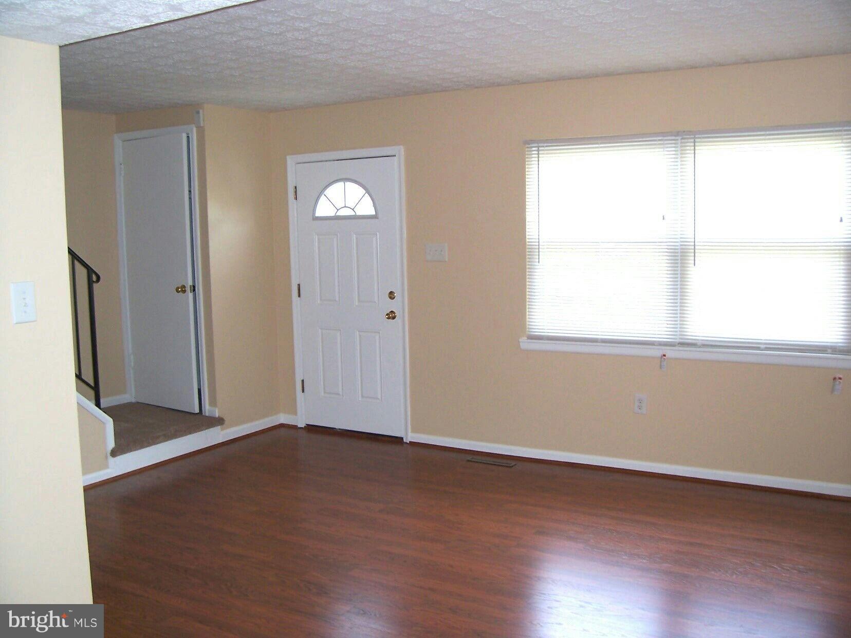 303 Redbud Road Edgewood, MD 21040 - Photo 2 of 16 an empty room with wooden floor and windows