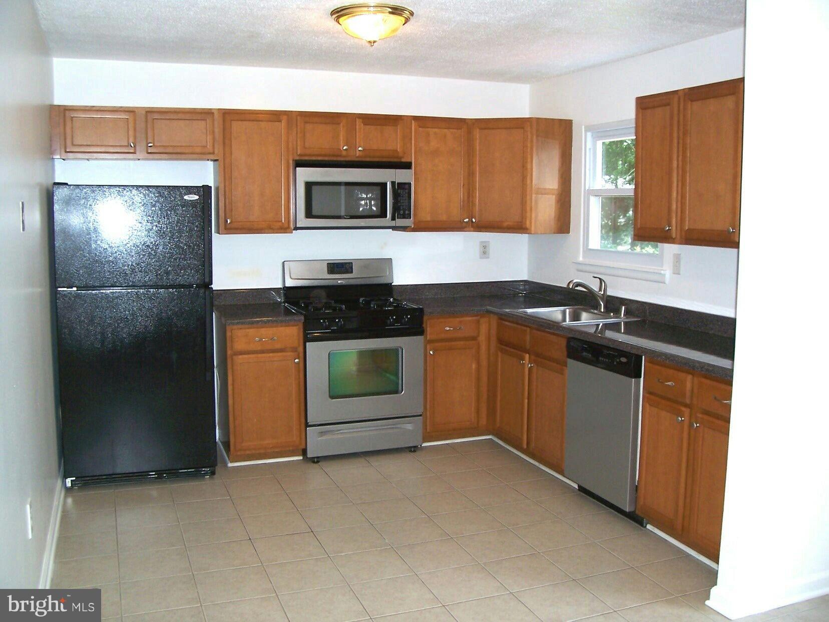 303 Redbud Road Edgewood, MD 21040 - Photo 4 of 16 a kitchen with stainless steel appliances granite countertop a sink and a stove