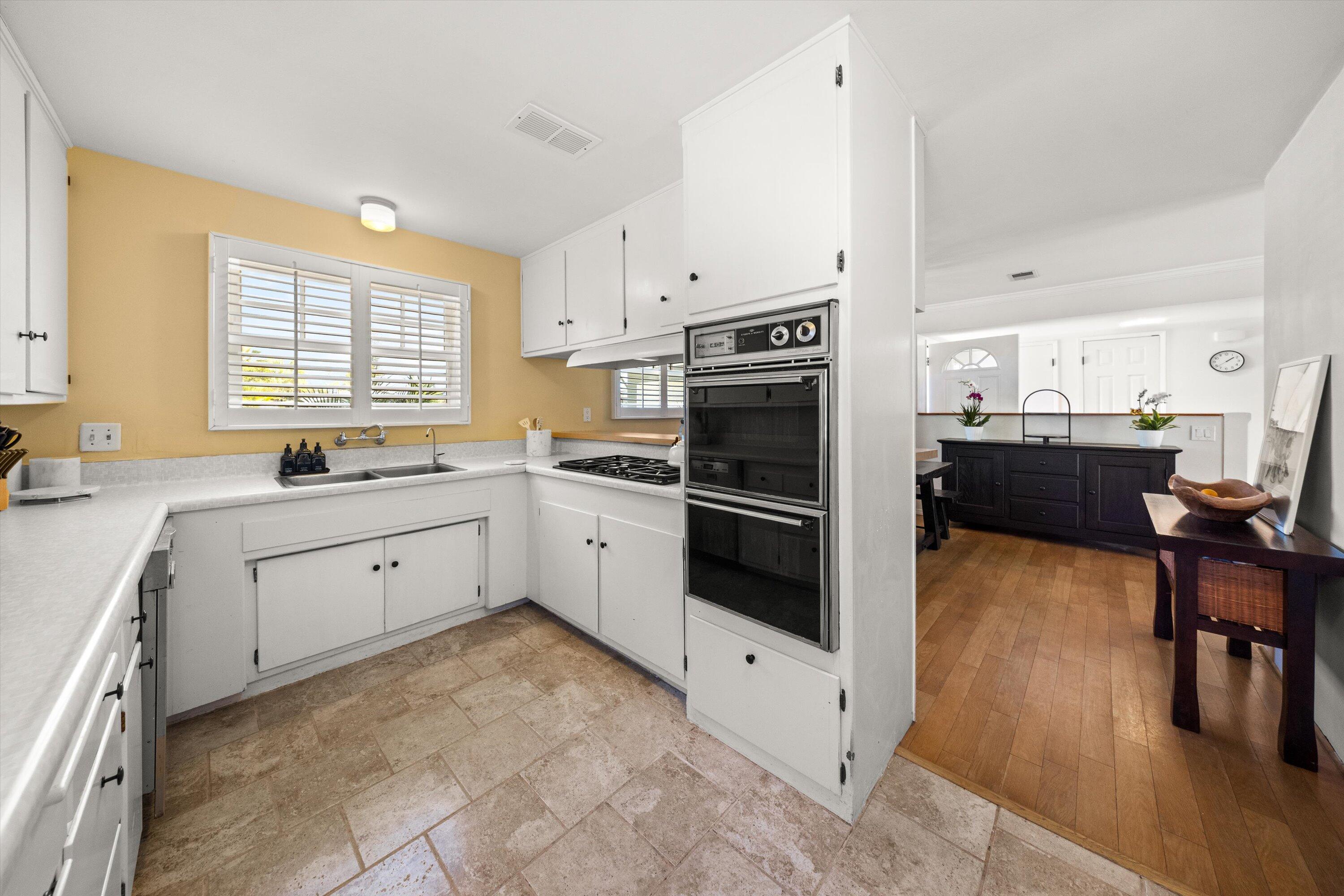 231 Salida Del Sol Santa Barbara, CA 93109 - Photo 10 of 30 a kitchen with stainless steel appliances a stove a sink and a refrigerator