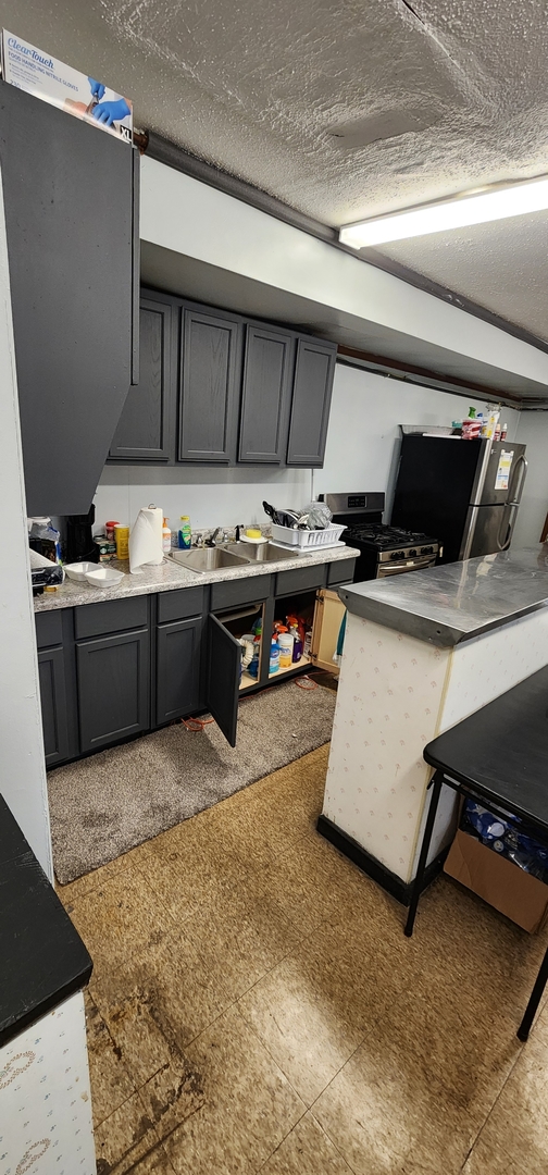 9312 South Halsted Street Chicago, IL 60620 - Photo 14 of 32 a kitchen with a stove and a refrigerator