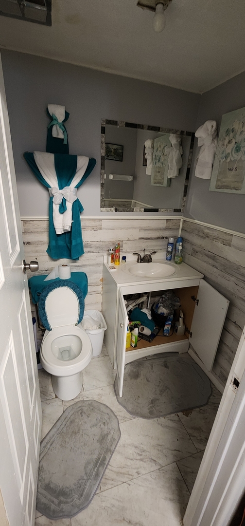 9312 South Halsted Street Chicago, IL 60620 - Photo 22 of 32 a bathroom with a stove and a toilet