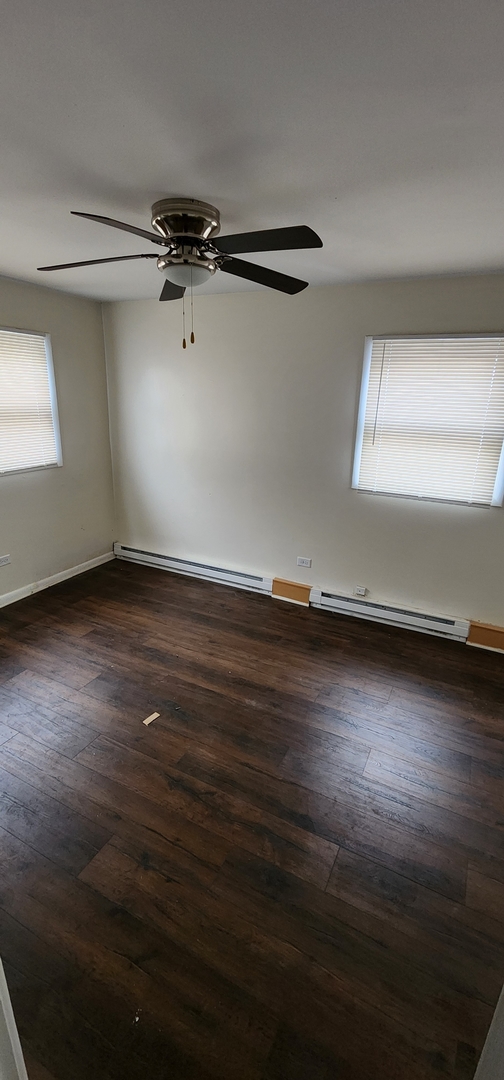 9312 South Halsted Street Chicago, IL 60620 - Photo 26 of 32 a view of a room with wooden floor and a window