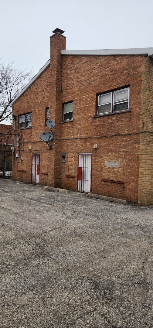 9312 South Halsted Street Chicago, IL 60620 - Photo 4 of 32 a front view of a house with a yard