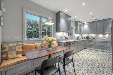 a kitchen with a dining table chairs and window