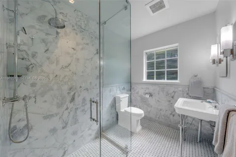 a bathroom with a sink toilet a shower and a mirror