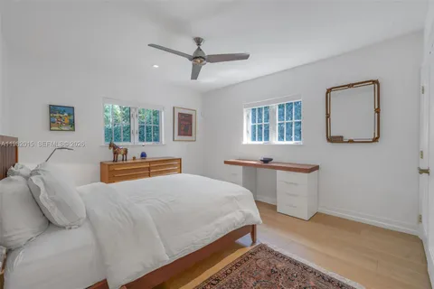 a bedroom with a bed window and couch