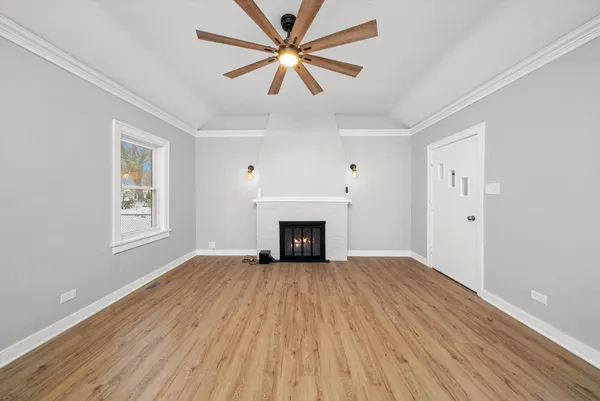 an empty room with windows and a fireplace