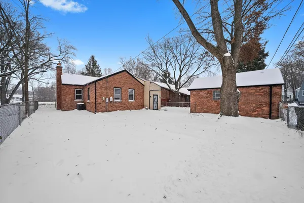 a view of house with a yard covered in snow