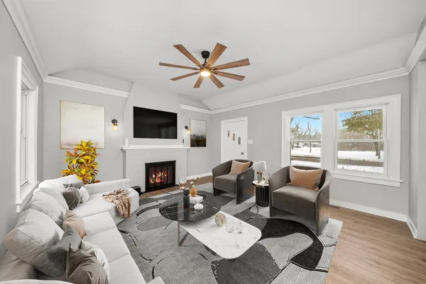 a living room with furniture a fireplace and a window