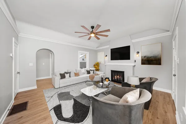 a living room with furniture a fireplace and a flat screen tv