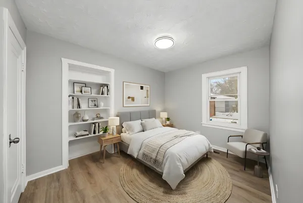 a bedroom with a bed and a window