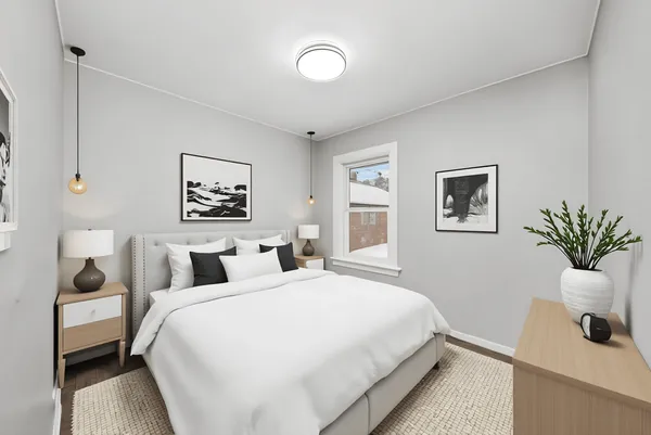 a bedroom with double bed and a potted plant