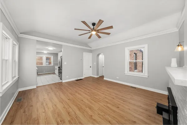 a view of a livingroom with a window and wooden floor