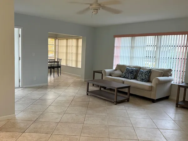 a living room with furniture and a floor to ceiling window