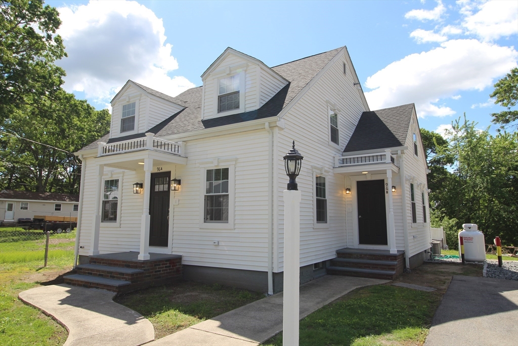96 Walnut Lane, Unit B Attleboro, MA 02703 - Photo 1 of 20 a front view of a house with a yard