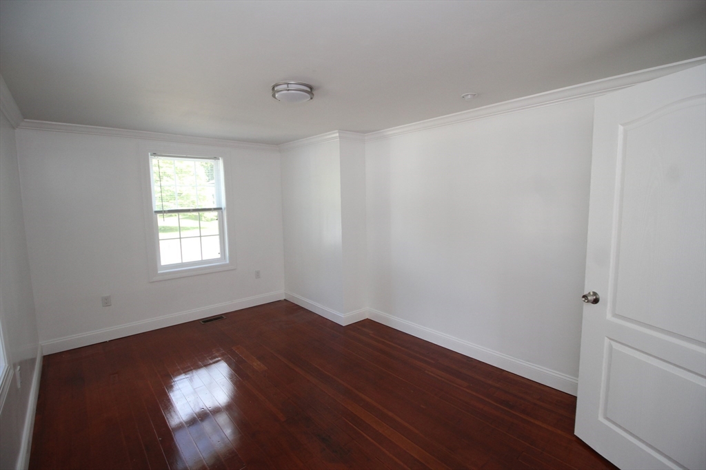 96 Walnut Lane, Unit B Attleboro, MA 02703 - Photo 17 of 20 an empty room with wooden floor and windows