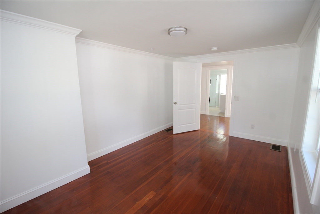 96 Walnut Lane, Unit B Attleboro, MA 02703 - Photo 19 of 20 a view of an empty room with wooden floor