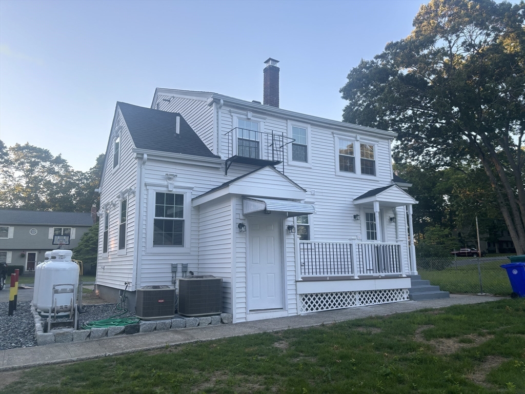 96 Walnut Lane, Unit B Attleboro, MA 02703 - Photo 20 of 20 a front view of a house with a garden