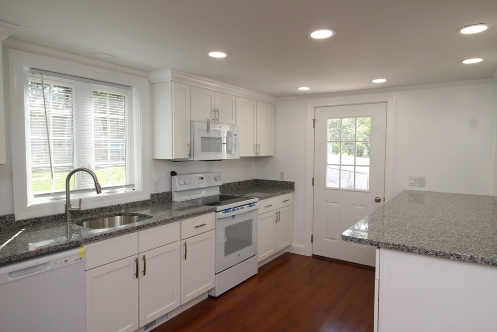 96 Walnut Lane, Unit B Attleboro, MA 02703 - Photo 8 of 20 a kitchen with granite countertop white cabinets and a sink