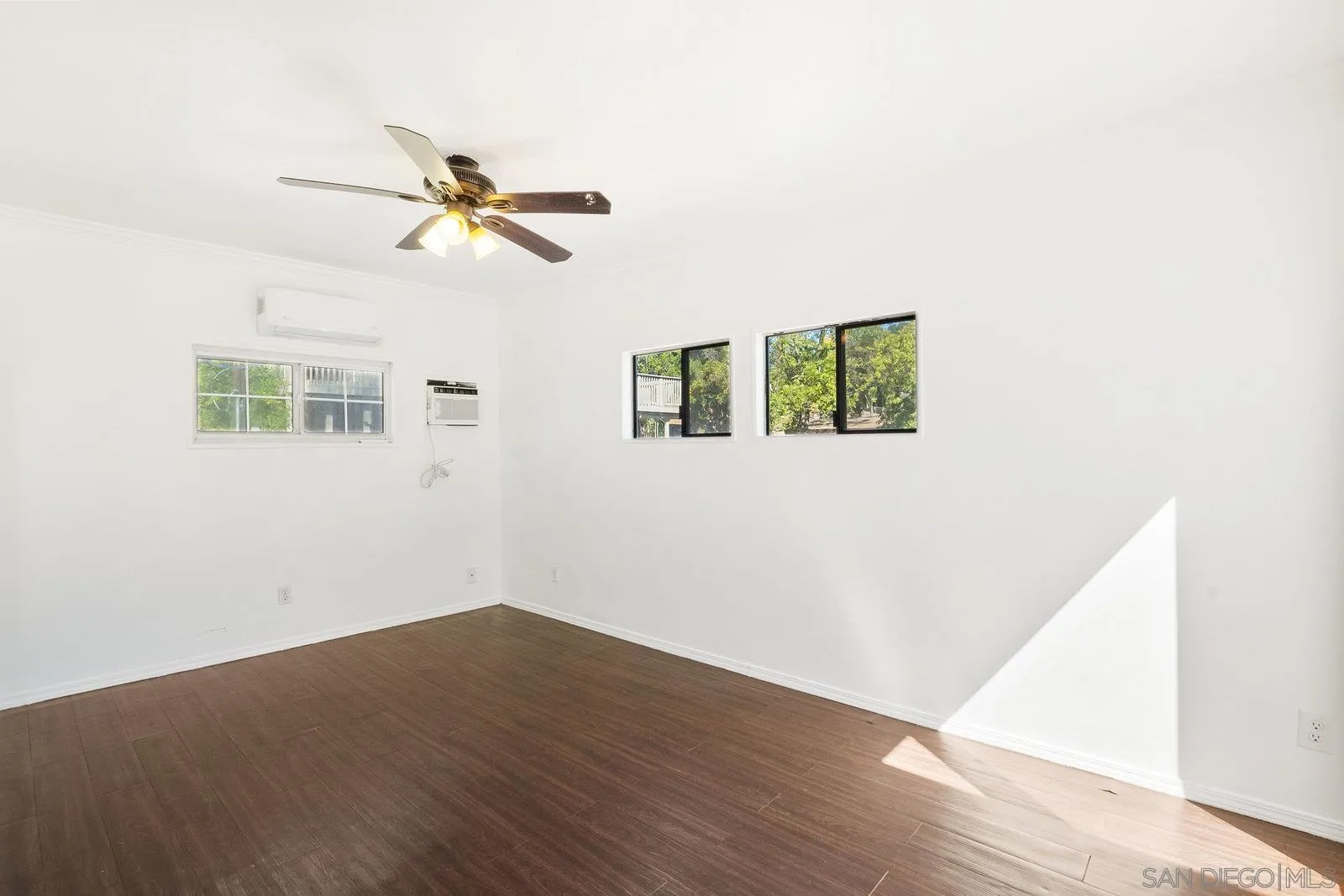 8545 Gardena Road Lakeside, CA 92040 - Photo 36 of 67 an empty room with wooden floor ceiling fan and window
