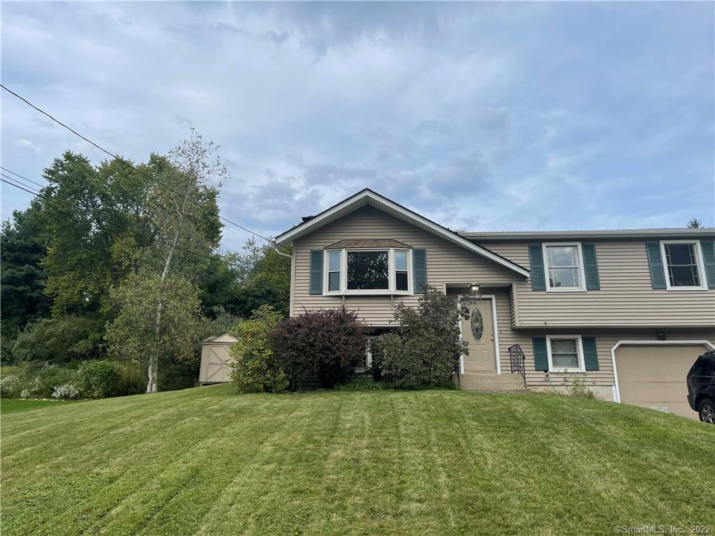 77 County Road Torrington, CT 06790 - Photo 1 of 1 a front view of a house with garden