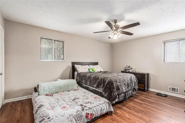 a bedroom with two beds and a chandelier