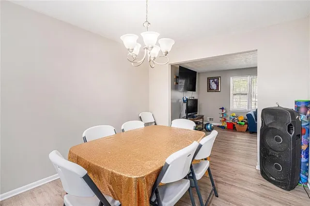 a view of a dining room with furniture and wooden floor