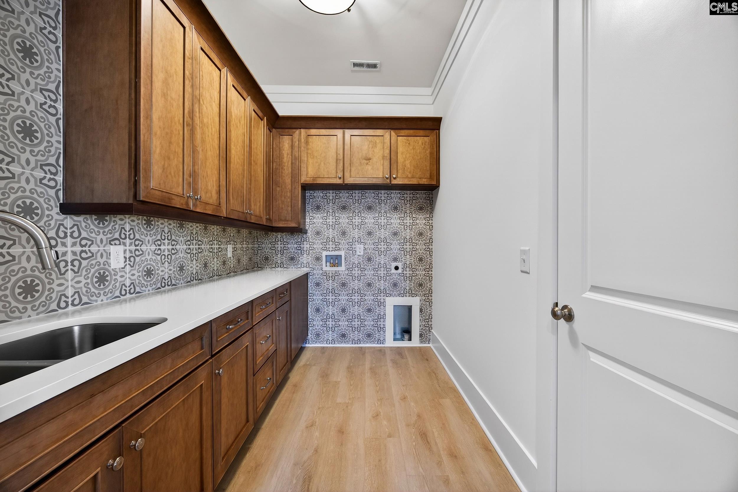 1318 Long Grove Way Lexington, SC 29072 - Photo 16 of 90 a kitchen with a sink a counter top space and cabinets