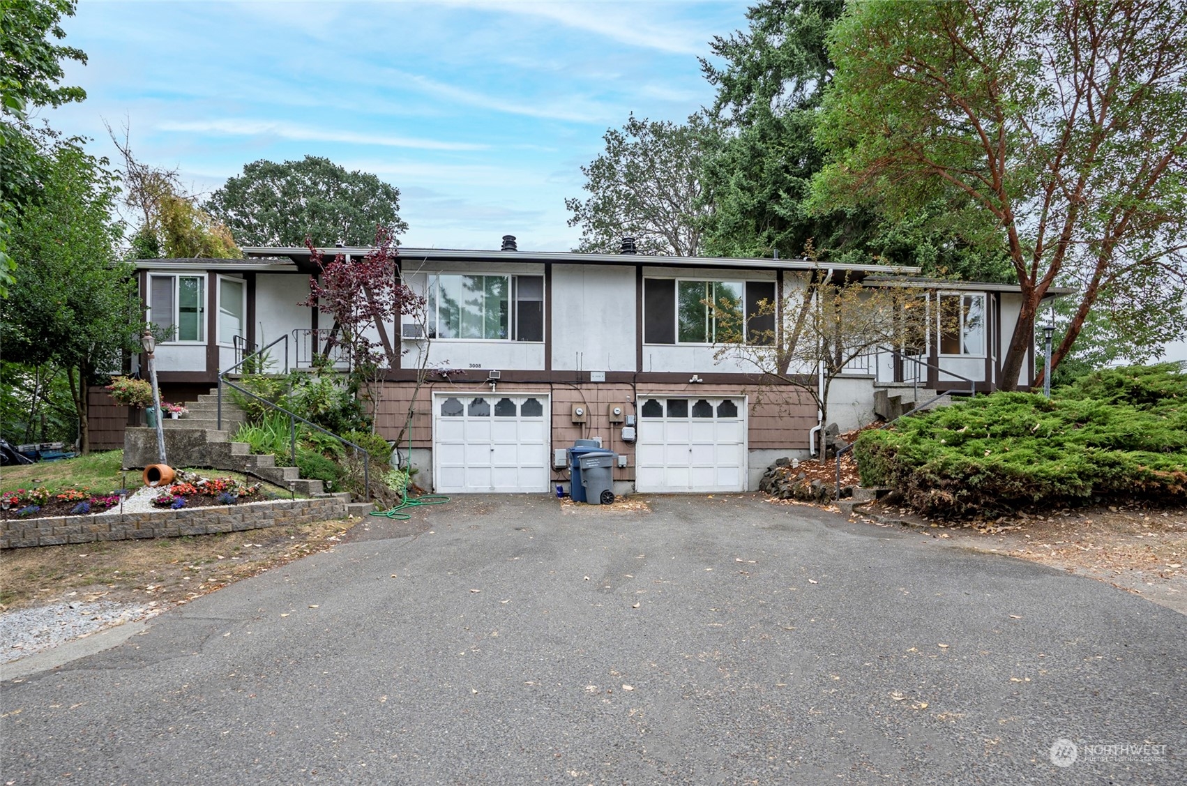 3006 Morrison Road West University Place, WA 98466 - Photo 1 of 32 a view of a house with garage and plants