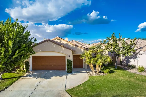 a view of a swimming pool with lawn chairs and a potted plants