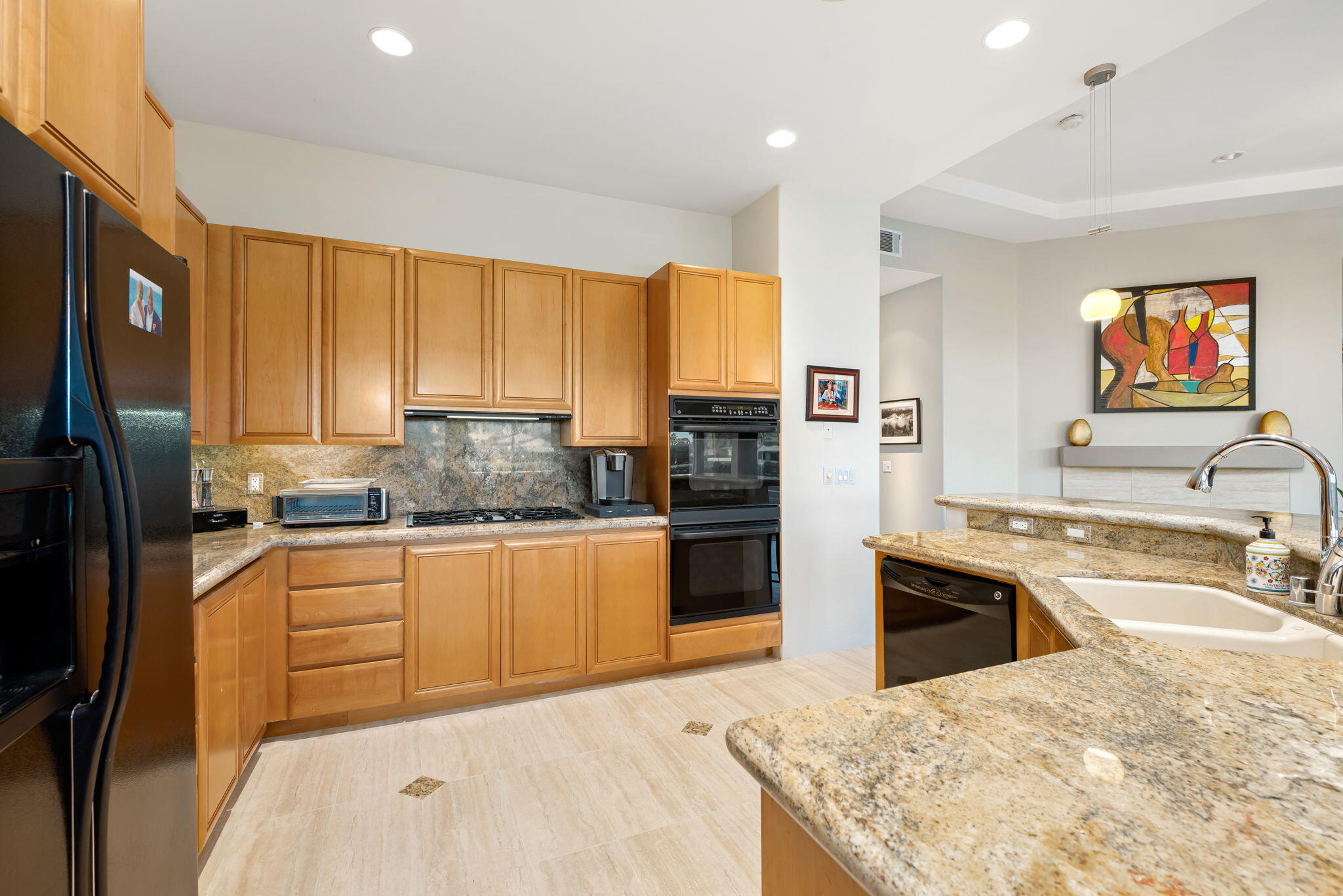 79440 Azahar La Quinta, CA 92253 - Photo 11 of 37 a kitchen with stainless steel appliances granite countertop a sink refrigerator and cabinets
