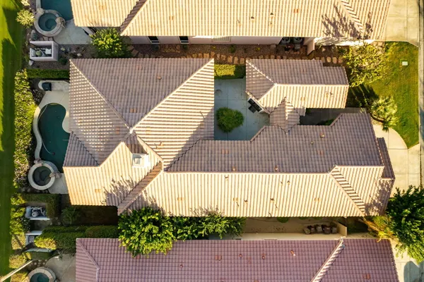 a spacious bedroom with a bed and flat screen tv