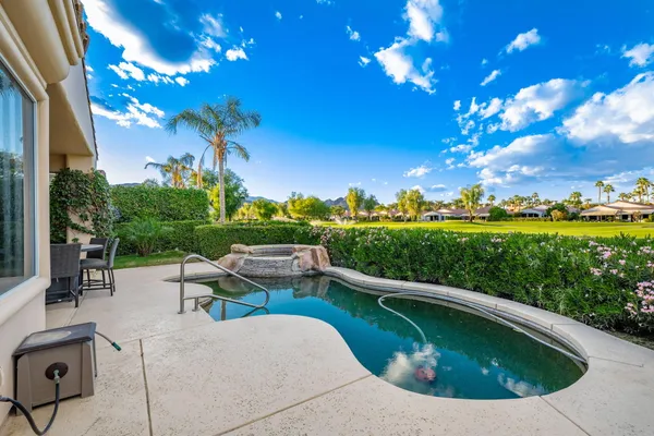 a view of an houses with swimming pool and outdoor space