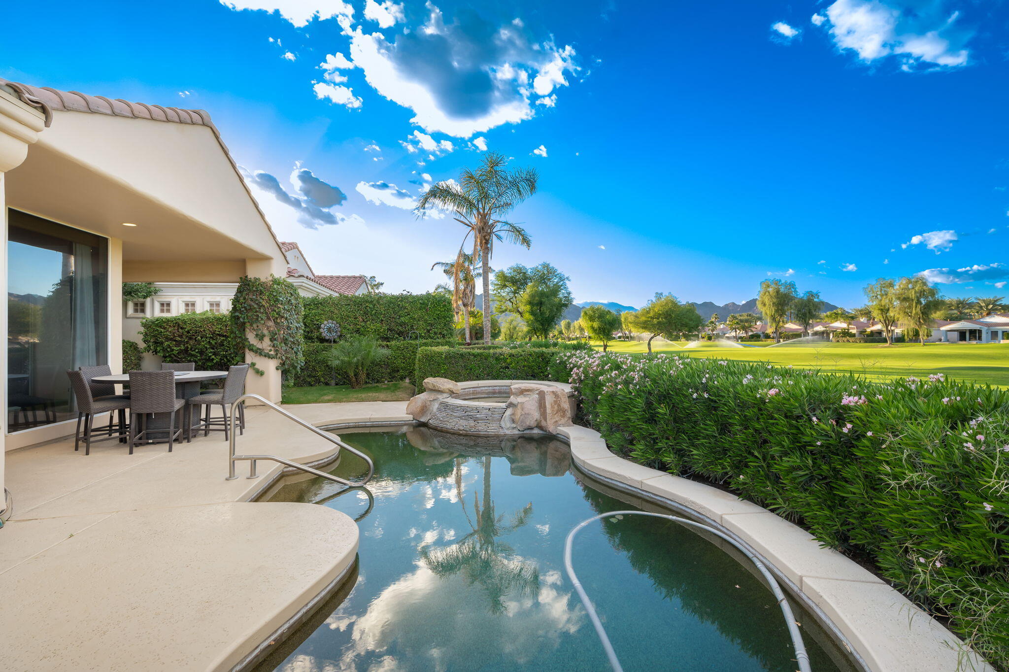 79440 Azahar La Quinta, CA 92253 - Photo 30 of 37 a view of a patio with couches table and chairs with plants and large trees