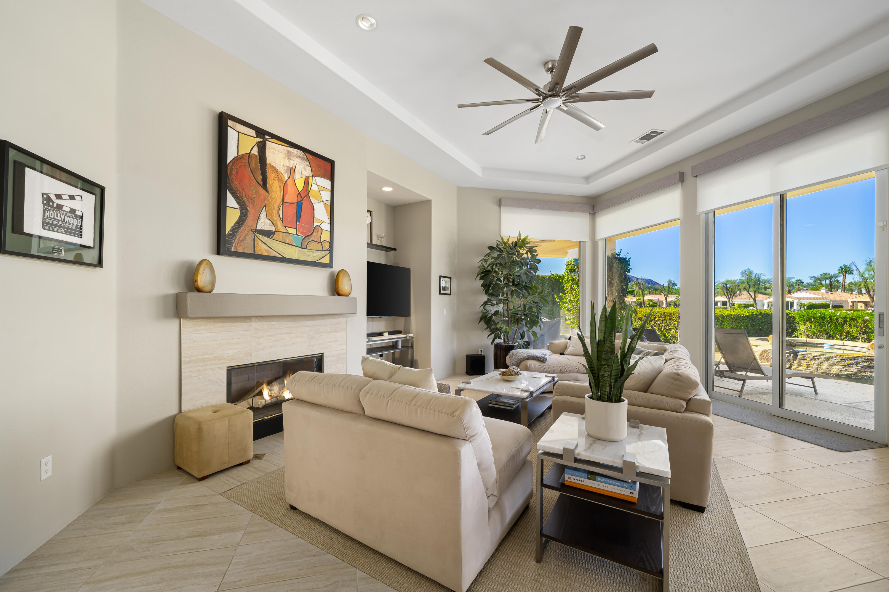 79440 Azahar La Quinta, CA 92253 - Photo 6 of 37 a living room with furniture a large window and a flat screen tv