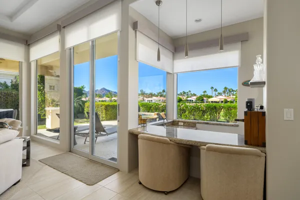 a view of a dining room with furniture and a potted plant