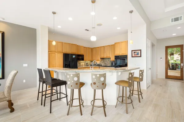 a kitchen with stainless steel appliances granite countertop a sink a stove cabinets and a microwave oven