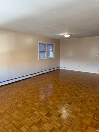 a view of a livingroom with wooden floor and a window