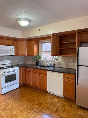 a kitchen with granite countertop a sink stainless steel appliances and cabinets