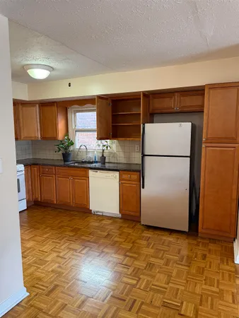 a kitchen with stainless steel appliances granite countertop a refrigerator sink and cabinets